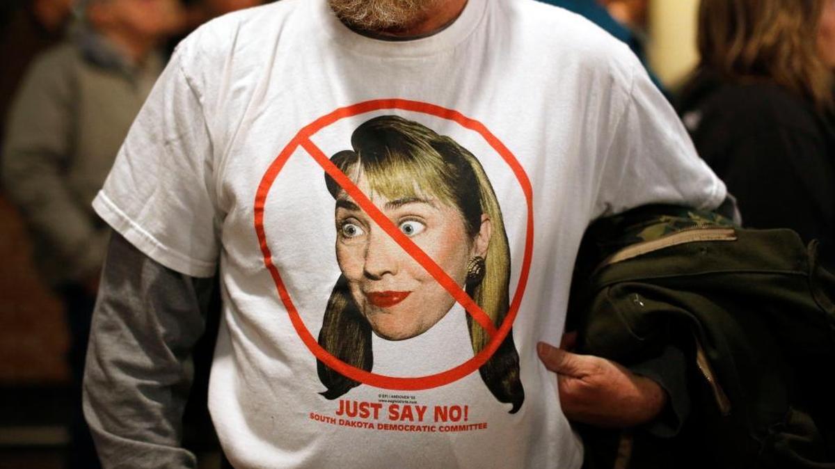 Frank McGreevy of Ames, Iowa, wears an anti-Hillary Clinton shirt as he listens to Republican presidential candidate Donald Trump speak at a rally at the Surf Ballroom in Clear Lake, Iowa on Jan. 9.