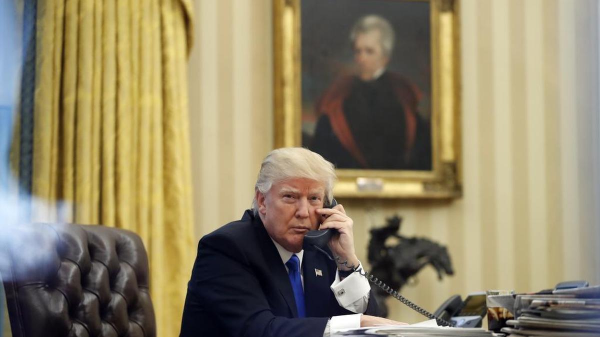 President Donald Trump speaks on the phone with Prime Minister of Australia Malcolm Turnbull in the Oval Office of the White House, Saturday, Jan. 28, 2017 in Washington.