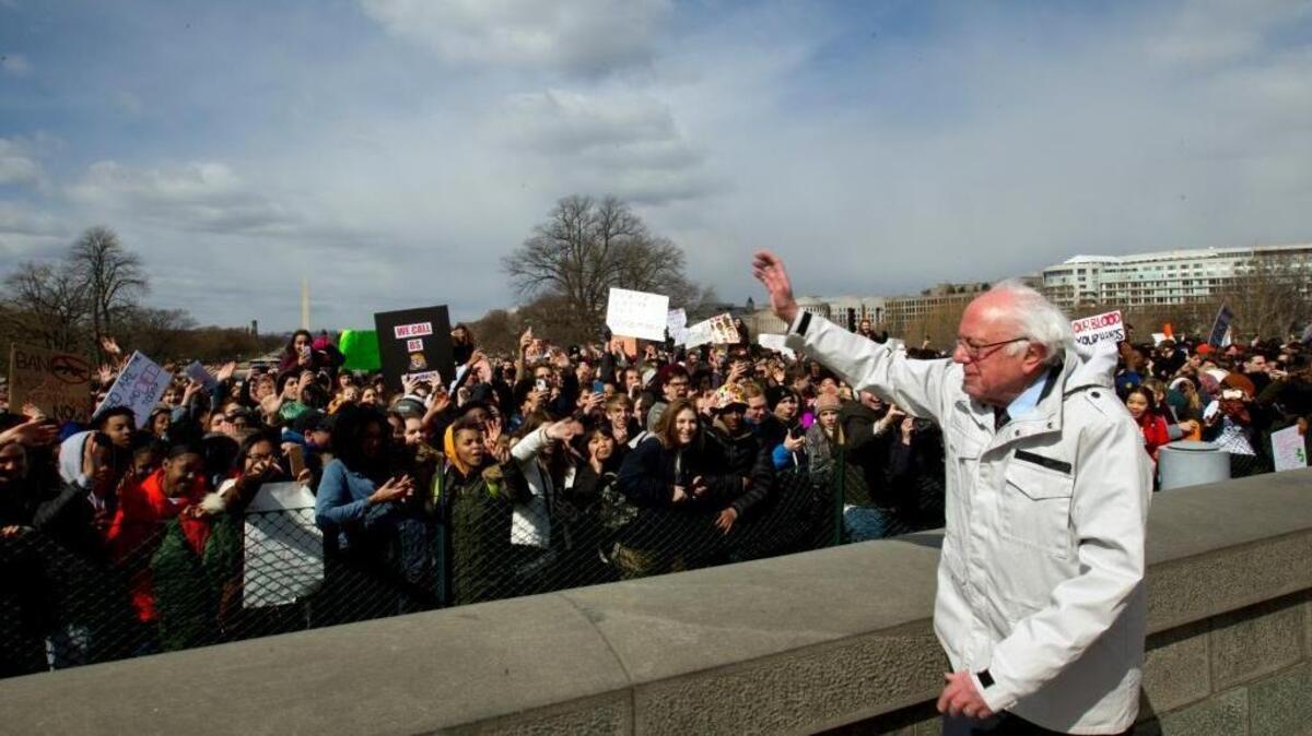Sen. Bernie Sanders, I-Vt., waves to students during a rally asking for gun control outside of the U.S. Capitol building, in Wednesday, March 14, 2018, in Washington. One month after a mass shooting in Florida, students and advocates across the country participate in walkouts and protests to call on Congress for action. (AP Photo/Jose Luis Magana)