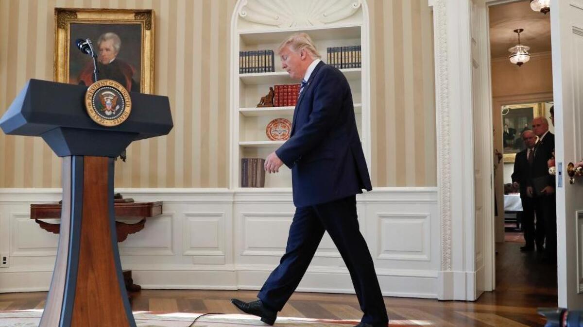 President Donald Trump walks to the podium to speak in the Oval Office of the White House in Washington, Thursday, Feb. 9, 2017, before Vice President Mike Pence swore-in in Attorney General Jeff Sessions, both of them are waiting in hallway.