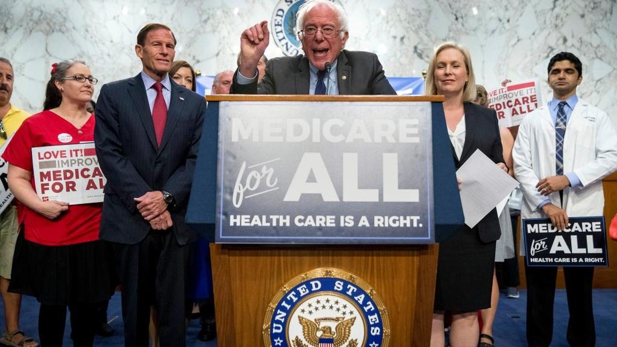 Sen. Bernie Sanders, I-Vt., center, joined by Sen. Richard Blumenthal, D-Conn., center left, Sen. Kirsten Gillibrand, D-N.Y., center right, and supporters, speaks at a news conference on Capitol Hill in Washington.