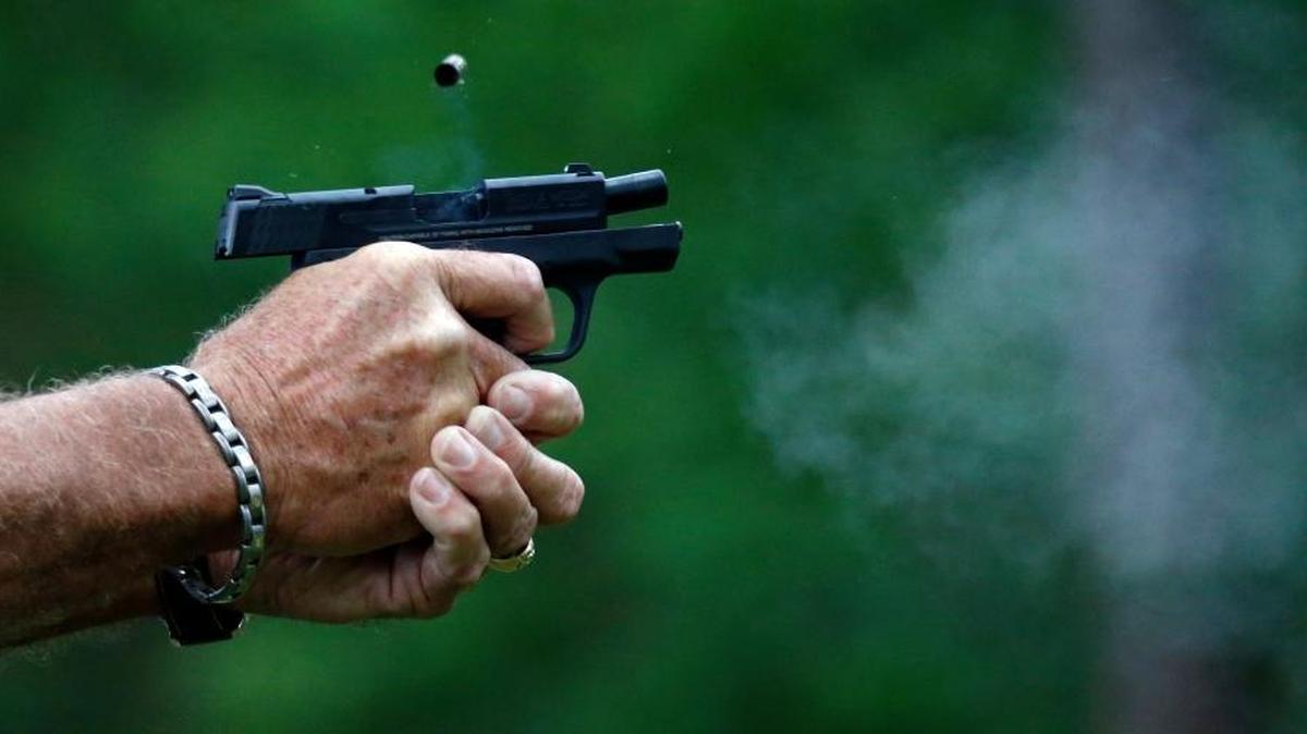 In this April 30, 2016 photograph, gun smoke and a spent round is ejected from a participant's automatic handgun during the live fire portion of a enhanced concealed carry class sponsored by Crestview Baptist Church for members and area residents in Petal, Miss. The 20 participants received hands on assistance during a practical shooting exercise, a thorough review on the fundamentals of safe handling of firearms in addition to a review of the basic and enhanced Mississippi Concealed Carry laws.