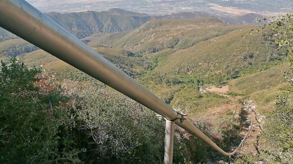 In this July 13, 2015, file photo, a pipeline carries water drawn from wells in the San Bernardino National Forest, Calif.