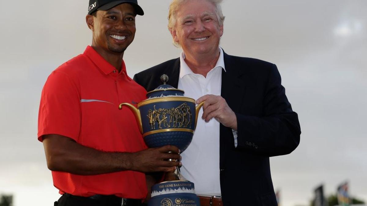 Tiger Woods stands with Donald Trump after winning the Cadillac Championship golf tournament March 10, 2013, in Doral, Fla.