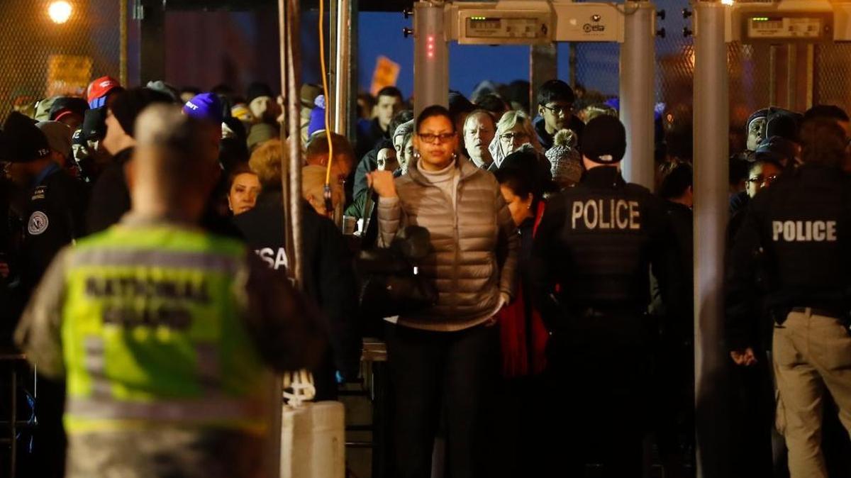 Spectators pass through a security checkpoint to gain access to Pennsylvania Avenue before the presidential inauguration of President-elect Donald Trump, Friday, Jan. 20, 2017, in Washington.
