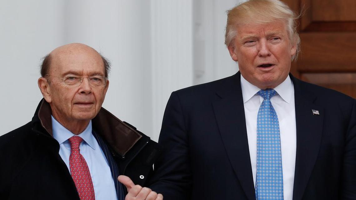 President-elect Donald Trump calls out to the news media as he greets investor Wilbur Ross when he arrives at the Trump National Golf Club Bedminster clubhouse, Nov. 20, 2016, in Bedminster, N.J.