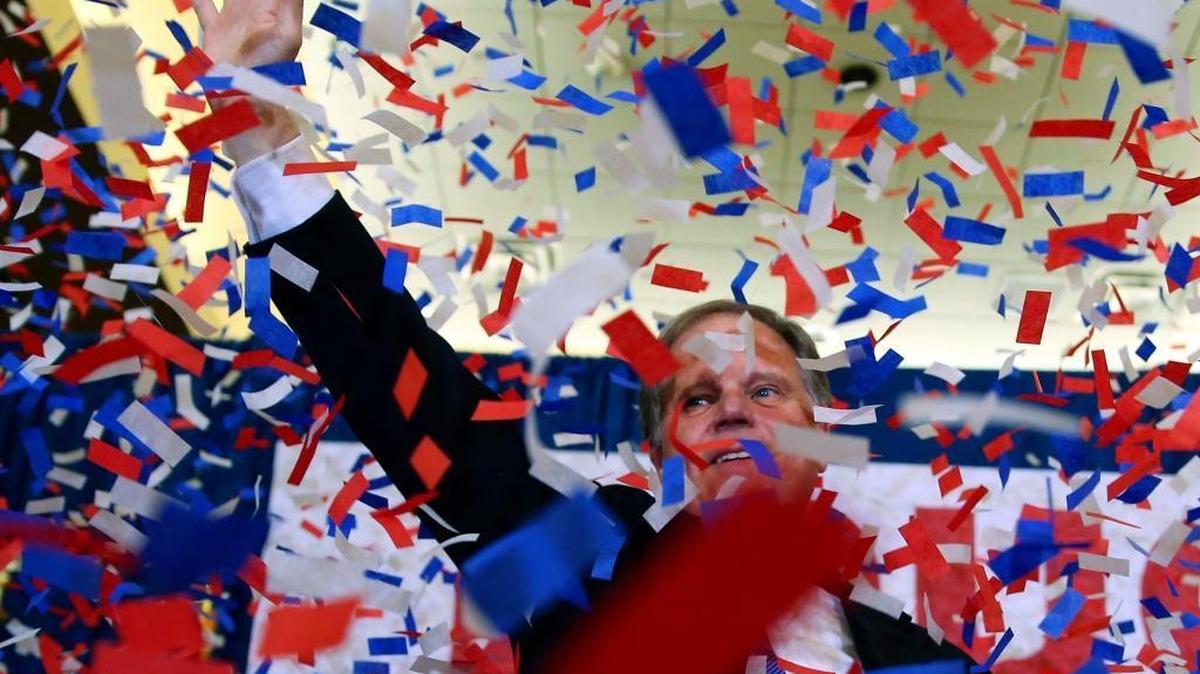 Democrat Doug Jones waves to supporters Tuesday, Dec. 12, 2017, in Birmingham, Ala. In a stunning victory aided by scandal, Jones won Alabama's special Senate election. Democratic enthusiasm continues at every level of government.