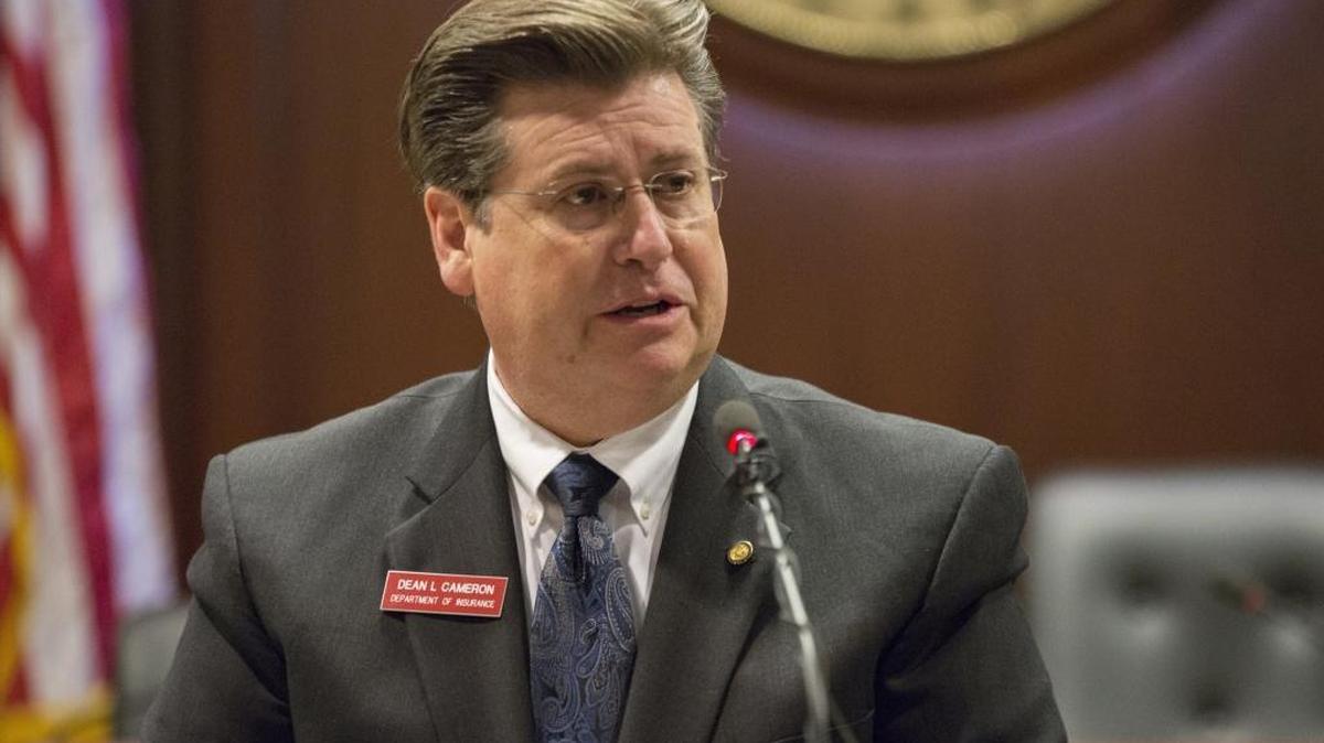 Idaho State Insurance Director Dean Cameron speaks to reporters Jan. 5 about a health insurance executive order.