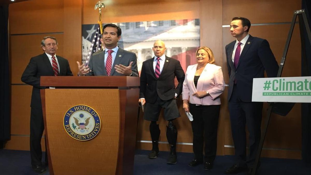 Rep. Carlos Curbelo, R-Fla., speaks to reporters at the Capitol about climate change on Monday, March 20, 2017. He is flanked by Republican Reps. Mark Sanford of South Carolina (from left), Brian Mast and Ileana Ros-Lehtinen of Florida and Ryan Costello of Pennsylvania.