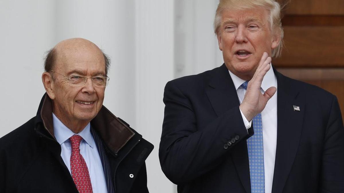 President-elect Donald Trump calls out to media as he greets investor Wilbur Ross at the Trump National Golf Club Bedminster clubhouse, Nov. 20, 2016, in Bedminster, N.J.