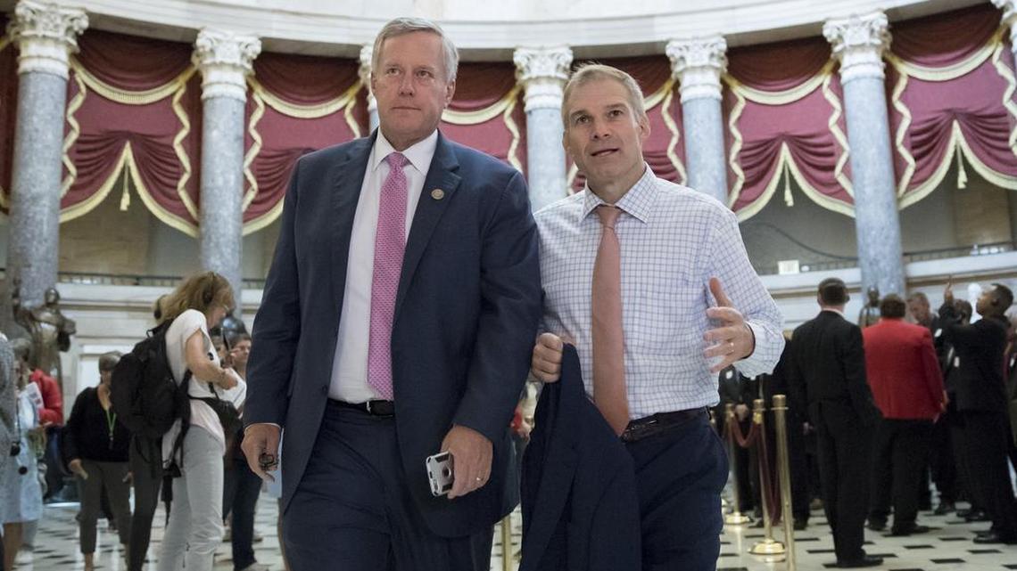 Rep. Mark Meadows, R-N.C., chairman of the conservative House Freedom Caucus, and Rep. Jim Jordan, R-Ohio, a key member of the group, walk through Statuary Hall at the Capitol in Washington, Wednesday, Sept. 13, 2017.