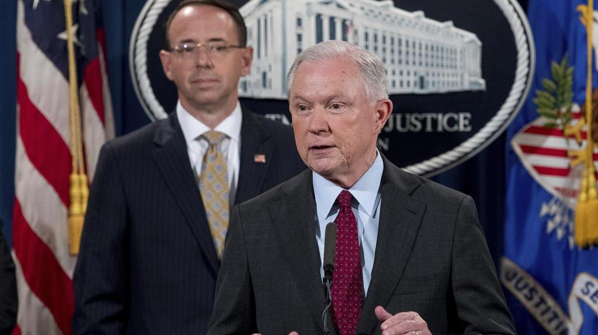 Attorney General Jeff Sessions accompanied by Deputy Attorney General Rod Rosenstein, left, speaks at a news conference to announce an international cybercrime enforcement action at the Department of Justice, Thursday, July 20, 2017, in Washington.
