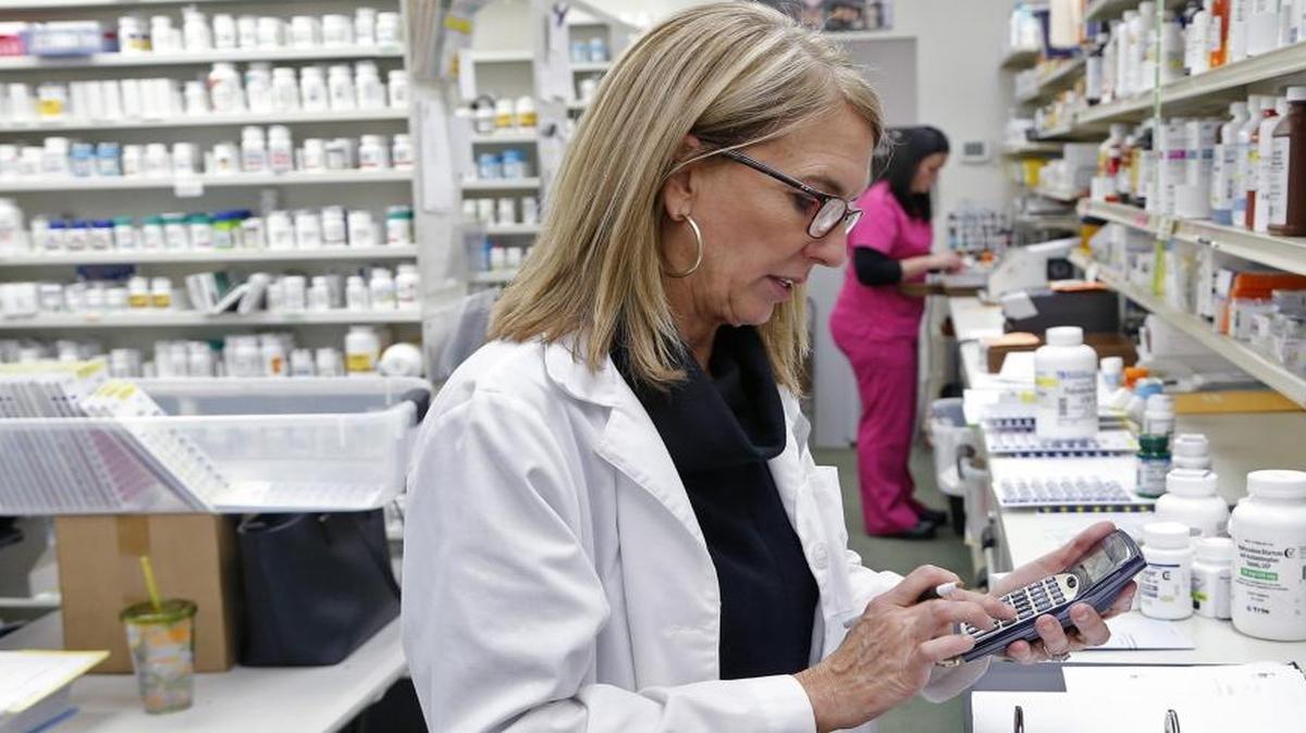 Third generation pharmacist Dr. Paige Thomas Houston uses a calculator as she works at her small business, Thomas Drug Store, in Dunn, NC on Jan. 20, 2016. Many small independently-owned drug stores like hers struggle financially without regulation in the industry to ensure benefit management firms are appropriately reimbursing pharmacies for the drugs they dispense.