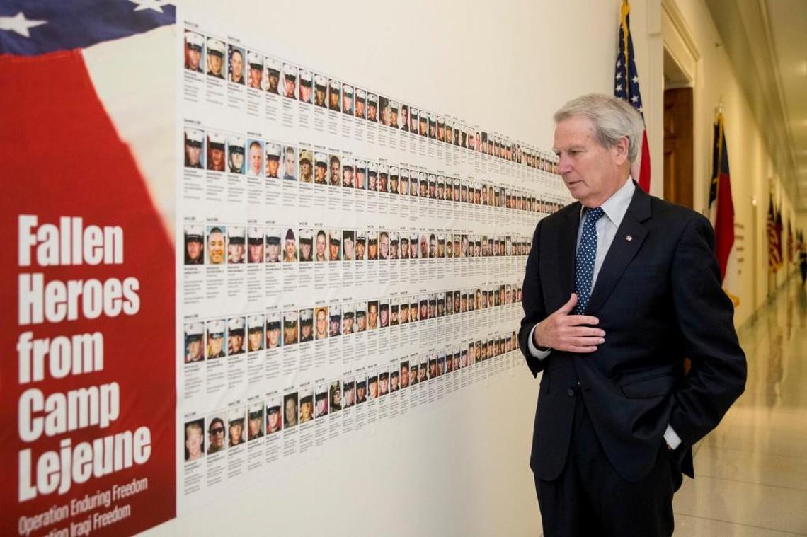 Rep. Walter Jones, R-N.C. looks at pictures of the soldiers killed this century based in Camp Lejeune along a hallway leading to his office on Capitol Hill, on Oct. 25, 2017, in Washington.