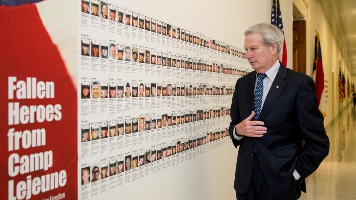 Rep. Walter Jones, R-N.C. looks at pictures of the soldiers killed this century based in Camp Lejeune along a hallway leading to his office on Capitol Hill, on Oct. 25, 2017, in Washington.