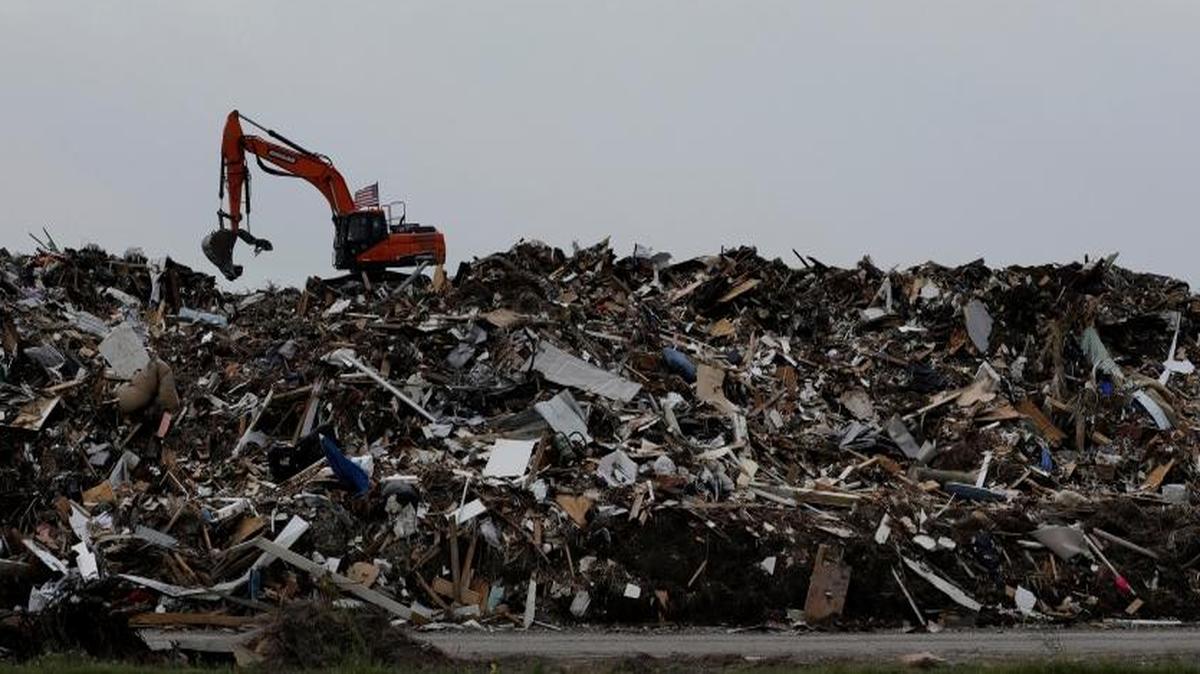 An excavator is used to move a mountain of debris created in the wake of Hurricane Harvey, Port Aransas, Texas. The storm damaged or destroyed 80 percent of local homes and businesses and arrived just before Labor Day, wiping out the lucrative summer season's final weeks.