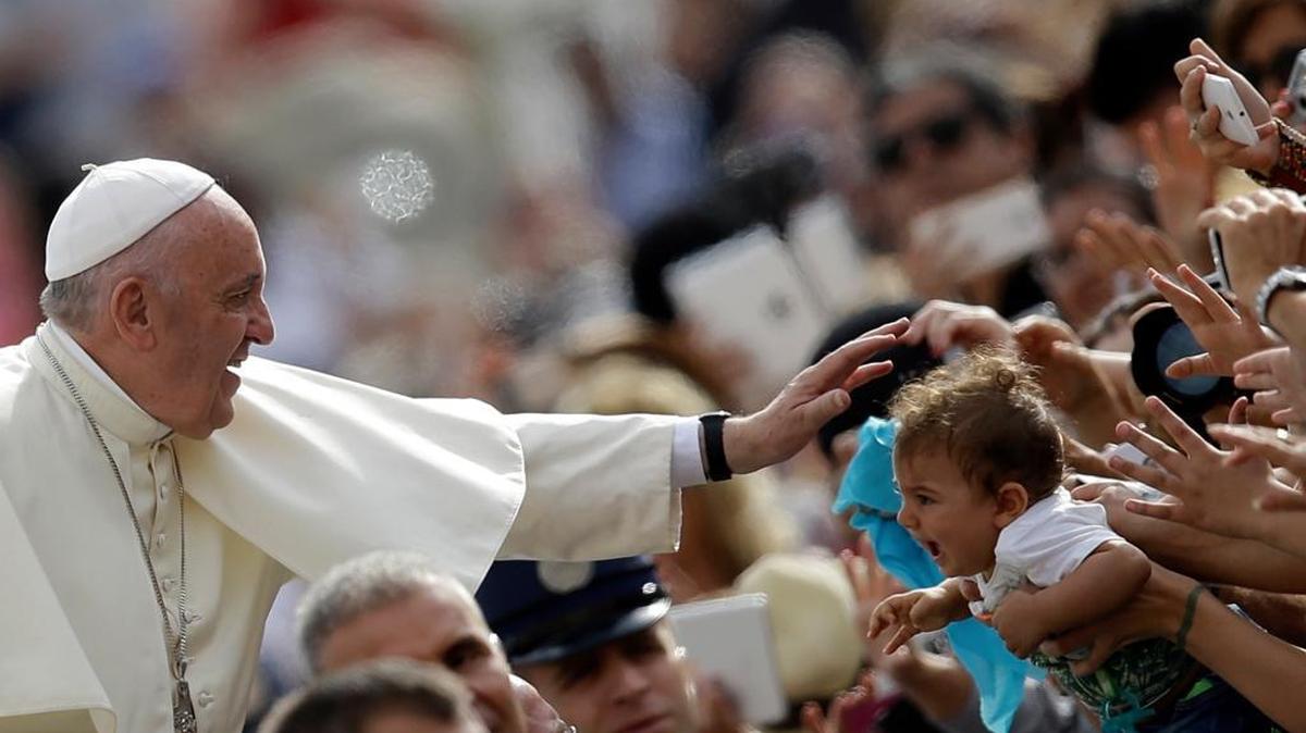 
Pope Francis blesses a child as he arrives for the weekly general audience in St. Peter's Square at the Vatican, Wednesday, Sept. 16, 2015. Hundreds of thousands are expected to try to get a glimpse of the pontiff when he visits Washington, New York and Philadelphia starting Tuesday.
