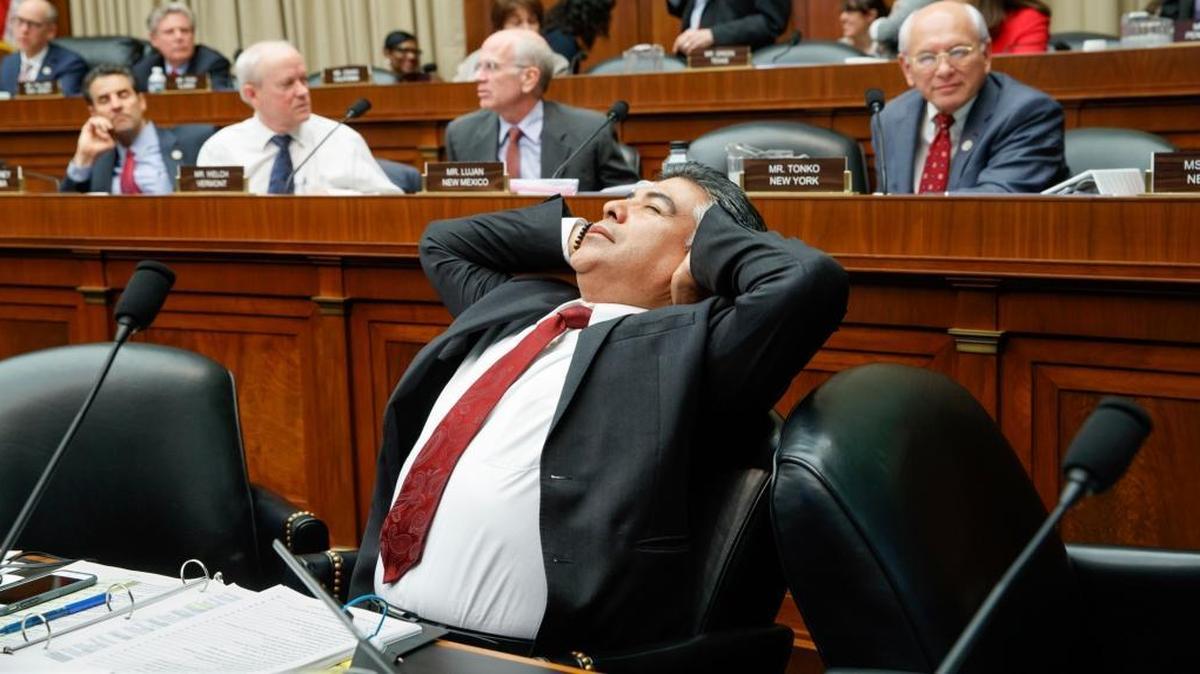 After working through the night, House Energy and Commerce Committee member Rep. Tony Cardenas, D-Calif., stretches while members of the committee argue the details of the GOP's "Obamacare" replacement bill, Thursday, March 9, 2017, on Capitol Hill in Washington.