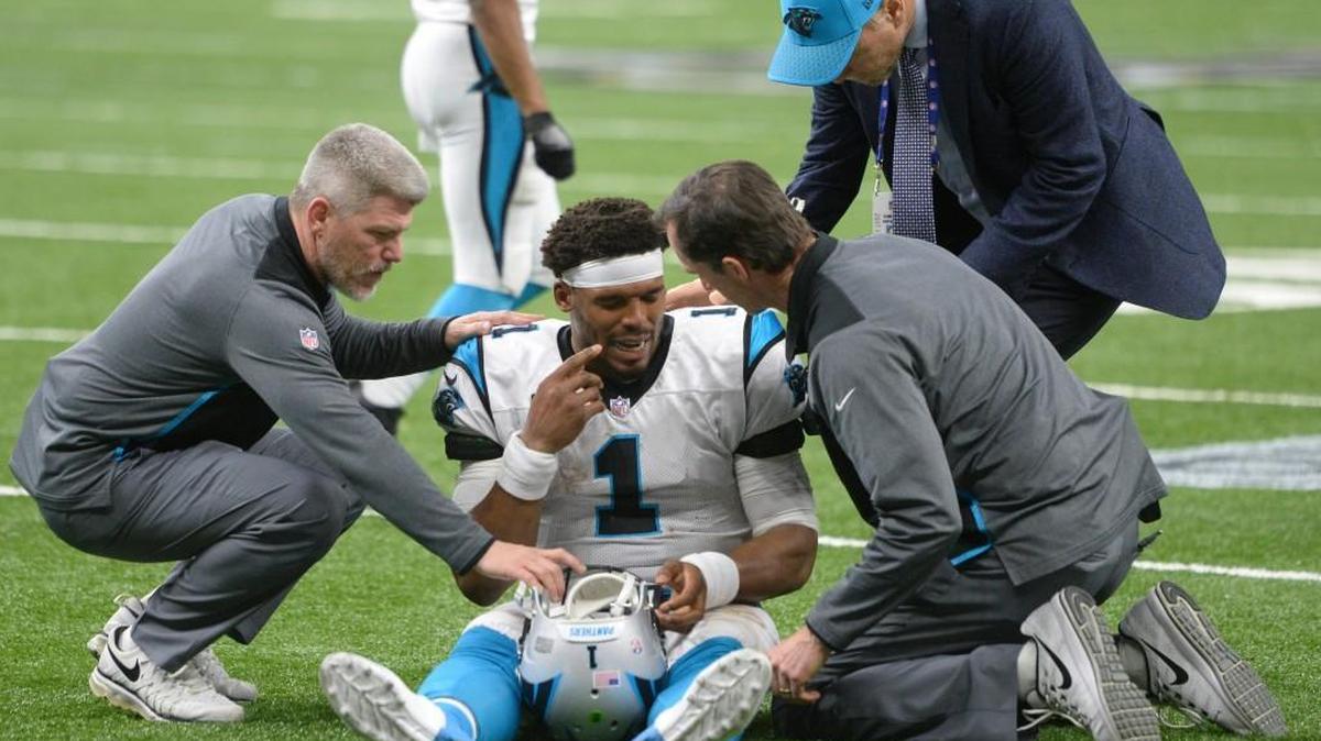 Carolina Panthers quarterback Cam Newton (1) is attended to after being poked in the eye on a play against the New Orleans Saints in the second half of their NFC Wild Card playoff game at the Mercedes-Benz Superdome on Sunday, January 7, 2018. The Saints won, 31-26.