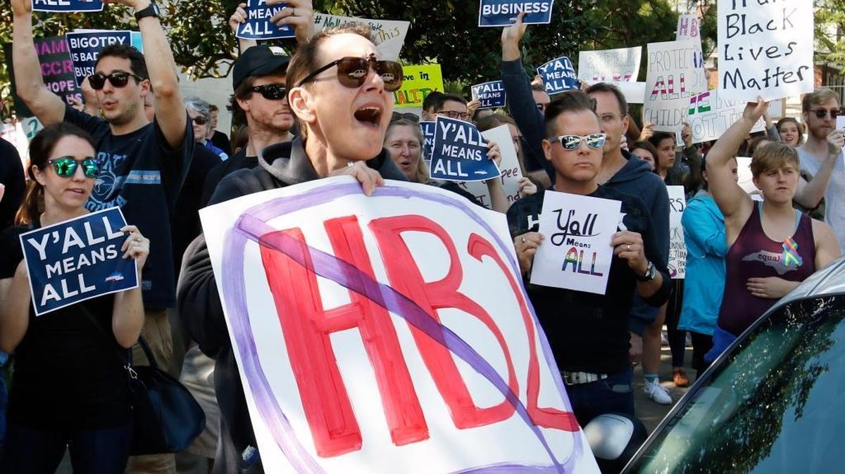 Earlier this month in Raleigh, HB2 protester Connie Jones, center, shouts with other demonstrators on North Blount Street across from the Governor's Mansion. A crowd of about 200 marched from in front of the NC legislature two blocks to peacefully stage their protest of the law.