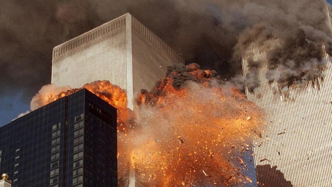Smoke billowed from World Trade Center Tower 1 and flames exploded from Tower 2 as it was struck by American Airlines Flight 175, in New York.
