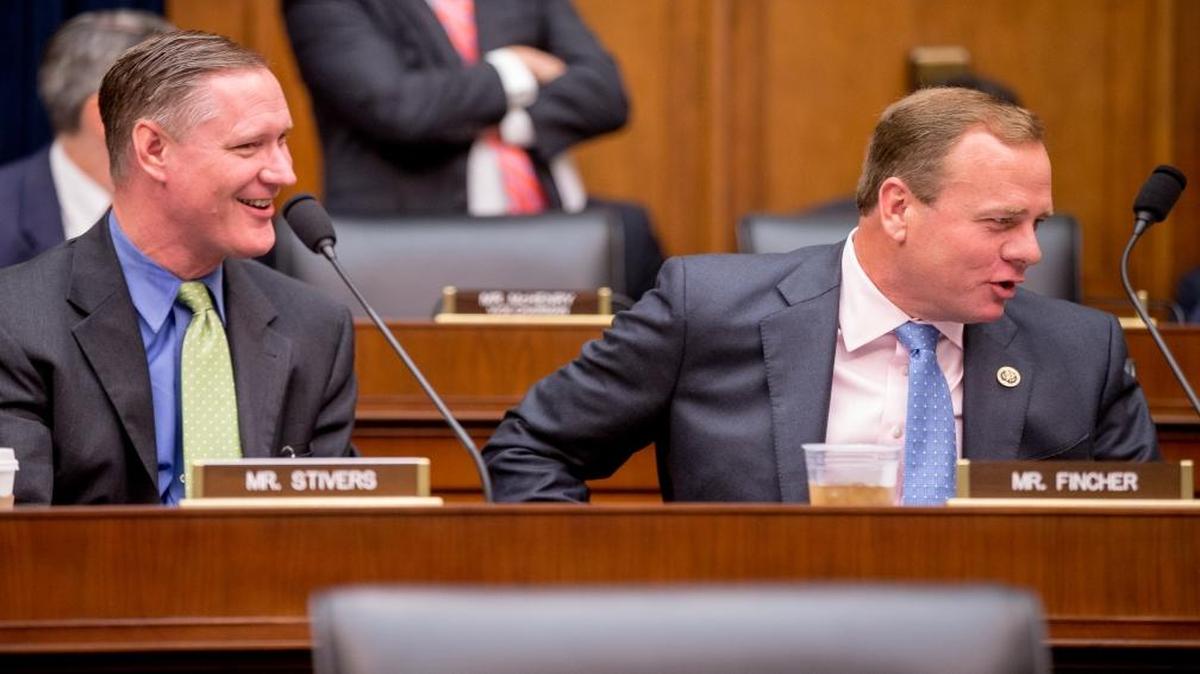 Rep. Steve Stivers, R-Ohio, and Rep. Stephen Fincher, R-Tenn., left and right, speak together before Treasury Secretary Jacob Lew arrives to testify on Capitol Hill in Washington, D.C., on June 17, 2015, before a House Financial Services committee hearing on the annual report of the Financial Stability Oversight Council.