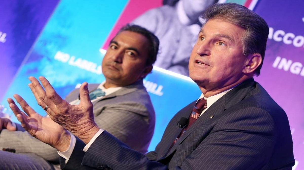 Sen. Joe Manchin, D-W.Va., right, wants Congress to pass a fix for a retired coal miners’ pension and health care fund before lawmakers go home for the month.