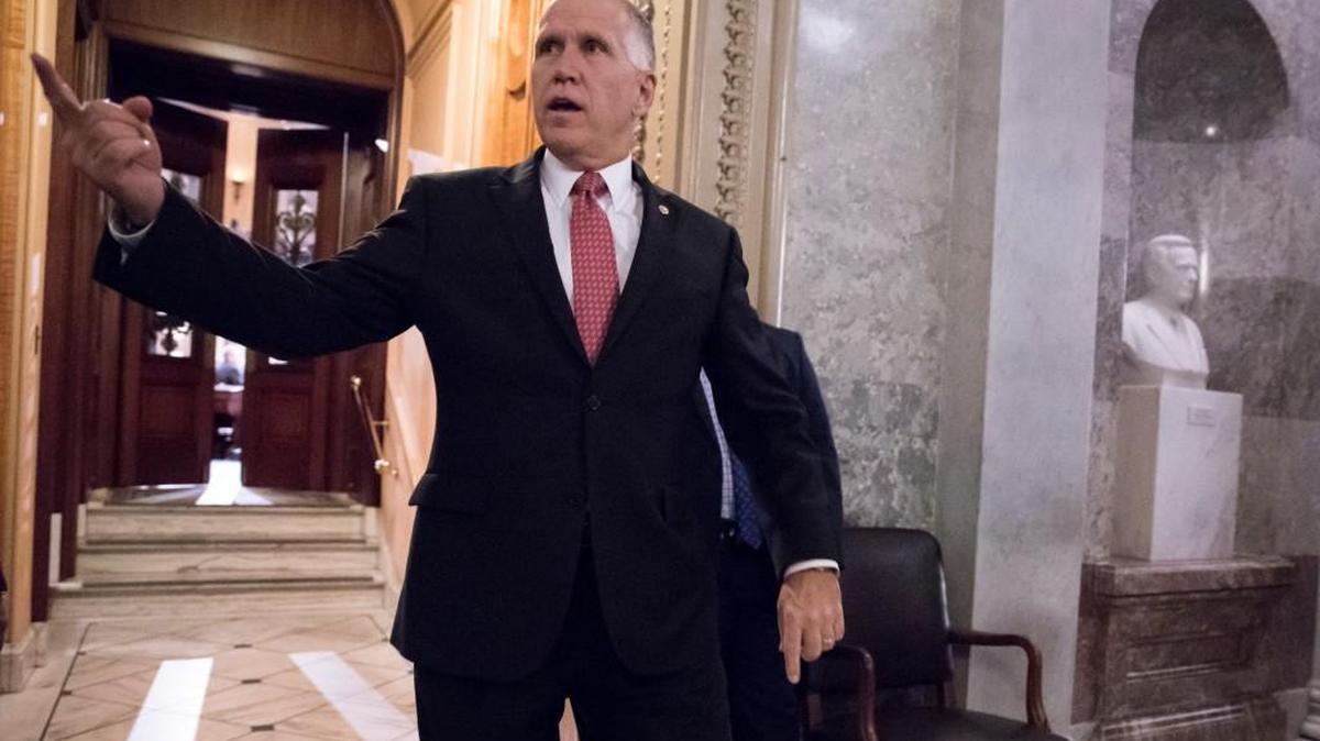 Sen. Thom Tillis, R-N.C., signals to a colleague on Capitol Hill in Washington on Nov. 27, 2017. Tillis planned to vote yes on the Senate’s tax plan.
