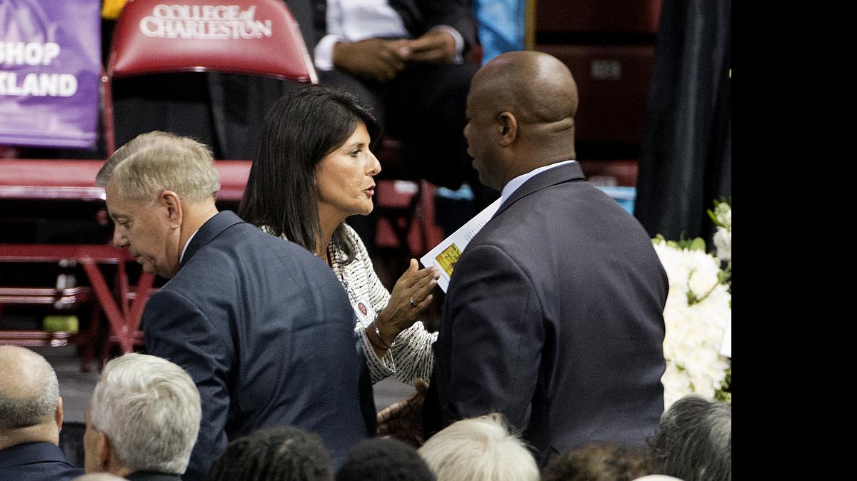 
Sen. Tim Scott, R-S.C., right, talks with Gov. Nikki Haley at the funeral service for Rev. Clementa Pinckney, June 26, 2015, in Charleston, S.C. Sen. Lindsey Graham, R-S.C., is at left.
