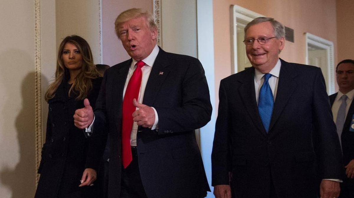President-elect Donald Trump, flanked by his wife Melania and Senate Majority Leader Mitch McConnell of Ky., gives a thumbs-up while walking on Capitol Hill in Washington, Thursday, Nov. 10, 2016, after their meeting.