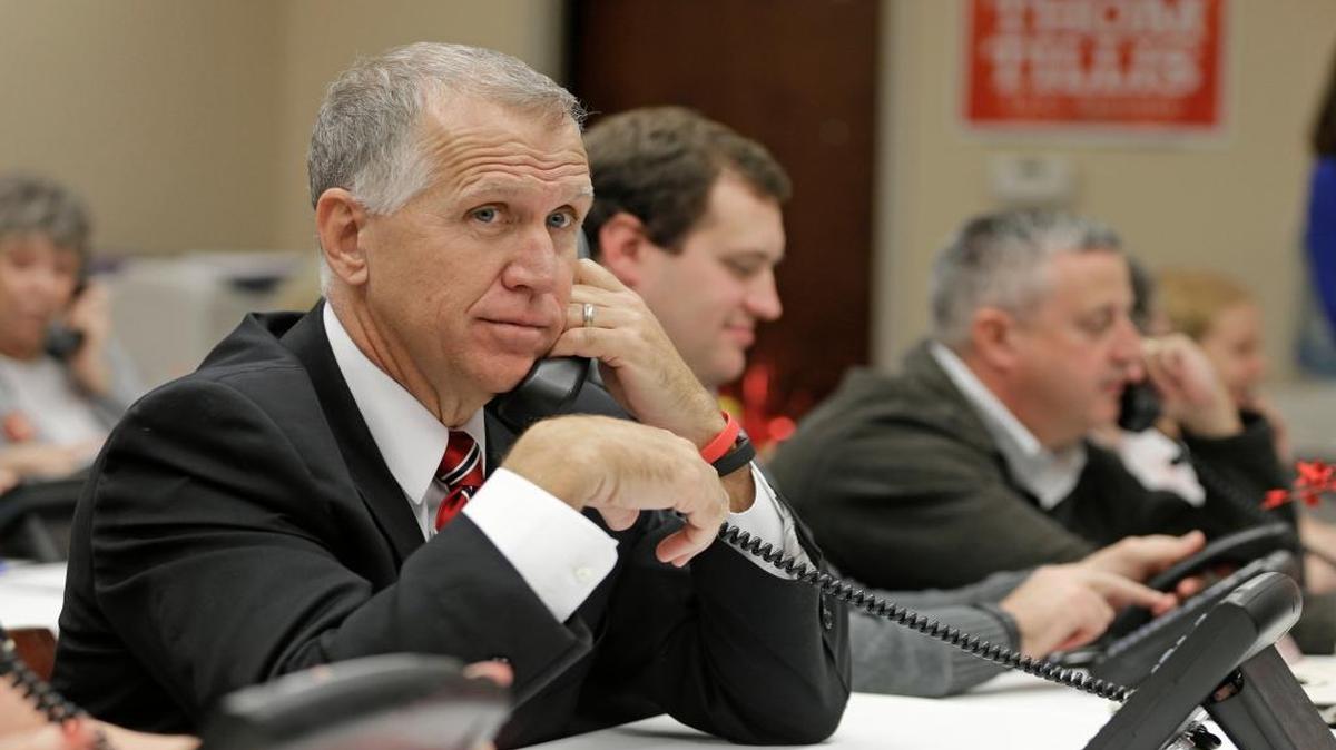 Republican Senate then-candidate Thom Tillis talks to a voter while making calls from his campaign office in Cornelius, N.C., Nov. 3, 2014.