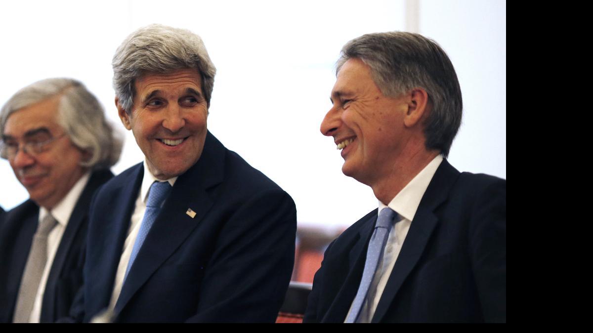 
U.S. Secretary of State John Kerry, left, talks with British Foreign Secretary Philip Hammond, right, as they meet with foreign ministers from China, Germany and France at an hotel in Vienna, Austria Monday, July 6, 2015. Iran's foreign minister said on Monday some differences still remained between Iran and six powers over the country's disputed nuclear programme ahead of Tuesday's deadline for a final agreement to end a 12-year-old dispute. 
