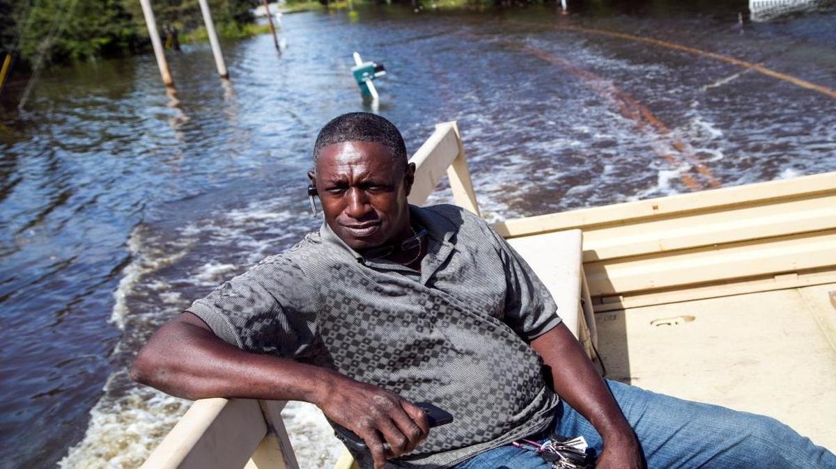 Jeff Linnen gets a ride from the National Guard through flood waters in the Dunbar community of Georgetown, S.C., on Friday, Oct. 9, 2015, where the roadway is barely visible below the water. South Carolina is still working on road repairs from the flooding, and has deeper underlying road problems. (Jason Lee/The Sun News via AP)
