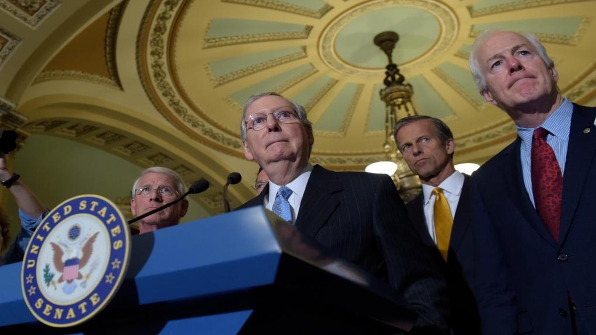 Senate Majority Leader Mitch McConnell, R-Ky., second from left, standing with, from left, Sen. Roger Wicker, R-Miss., Sen. John Thune, R-S.D., and Senate Majority Whip John Cornyn, R-Texas, listens to a question during a media availability on Capitol Hill in Washington on Tuesday, Sept. 13, 2016.