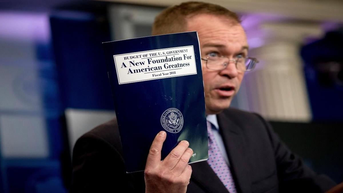 In this May 23, 2017, photo, Budget Director Mick Mulvaney holds up a copy of President Donald Trump’s proposed fiscal 2018 federal budget as he speaks to members of the media in the Press Briefing Room of the White House in Washington. Trump’s $4.1 trillion plan for the budget year beginning Oct. 1 generally proposes deep cuts in safety net programs, including Medicaid and the Children’s Health Insurance Program.