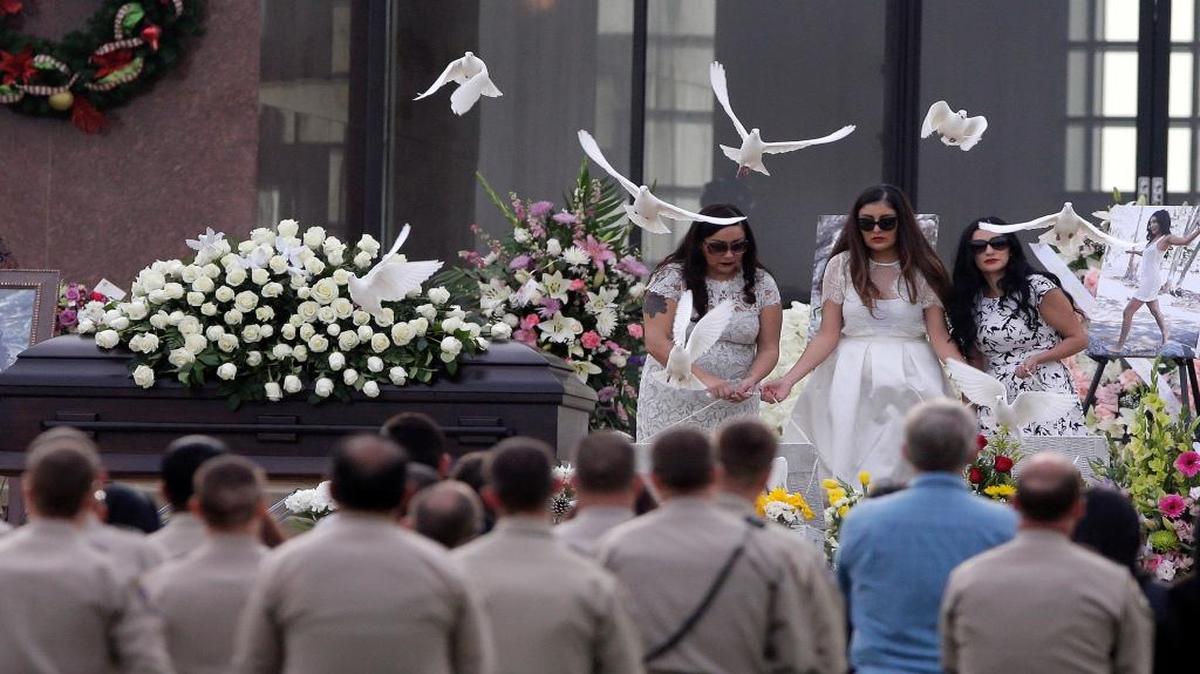 Yvette Velasco’s sisters release doves during her funeral Thursday. Velasco was one of the 14 people killed in the San Bernardino shootings.