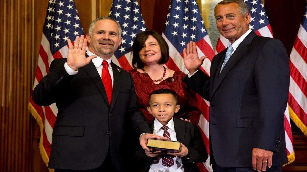 House Speaker John Boehner of Ohio administers the House oath to Rep. Tim Huelskamp, R-Kan., with his family, during a ceremonial re-enactment swearing-in ceremony, Tuesday, Jan. 6, 2015, in the Rayburn Room on Capitol Hill in Washington.
