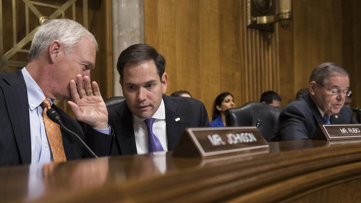 Sen. Marco Rubio, R-Fla., center, confers with Sen. Ron Johnson, R-Wisc., left, as Sen. Bob Menendez, D-N.J., far right, speaks as the Senate Foreign Relations Subcommittee on the Western Hemisphere.