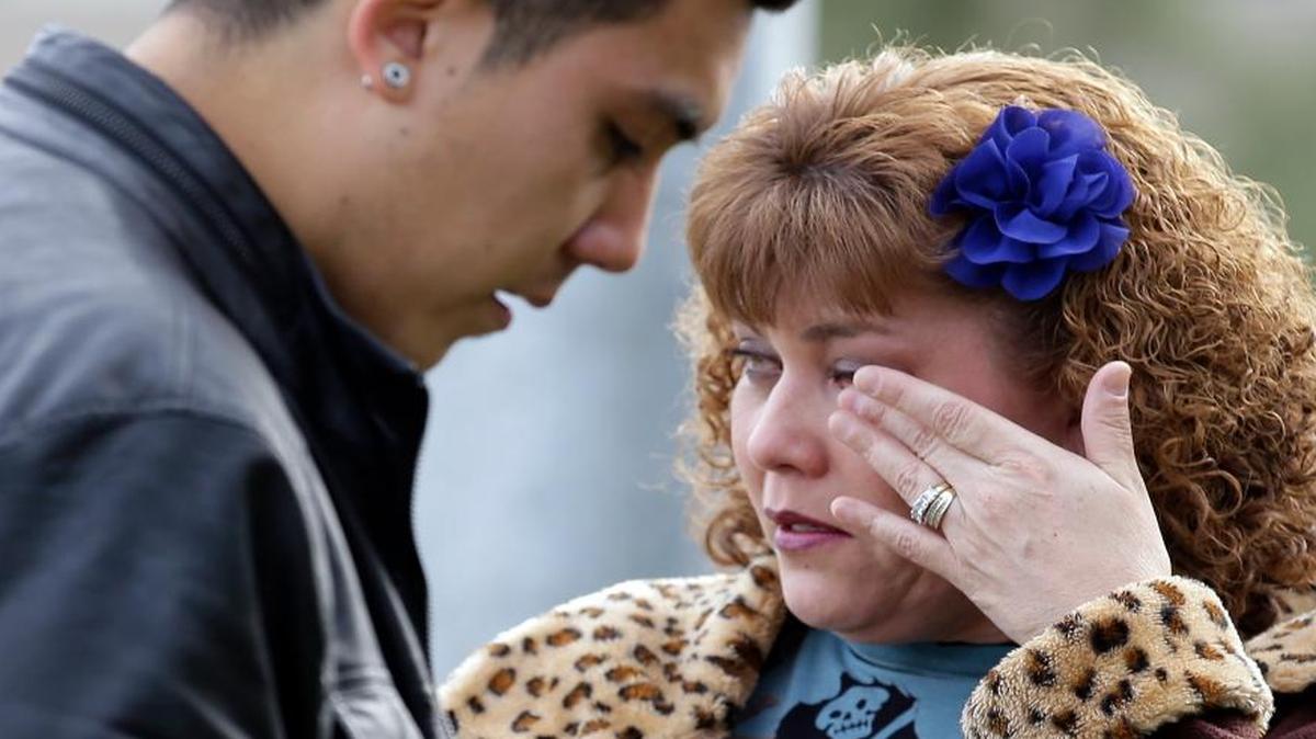 Lisa Gonzalez waited Thursday to return to her home, which police had cordoned off in the neighborhood where police shot it out with the suspects in Wednesday’s massacre in San Bernardino. The two suspects were killed. California lawmakers in Washington remain divided over what to do about gun violence.