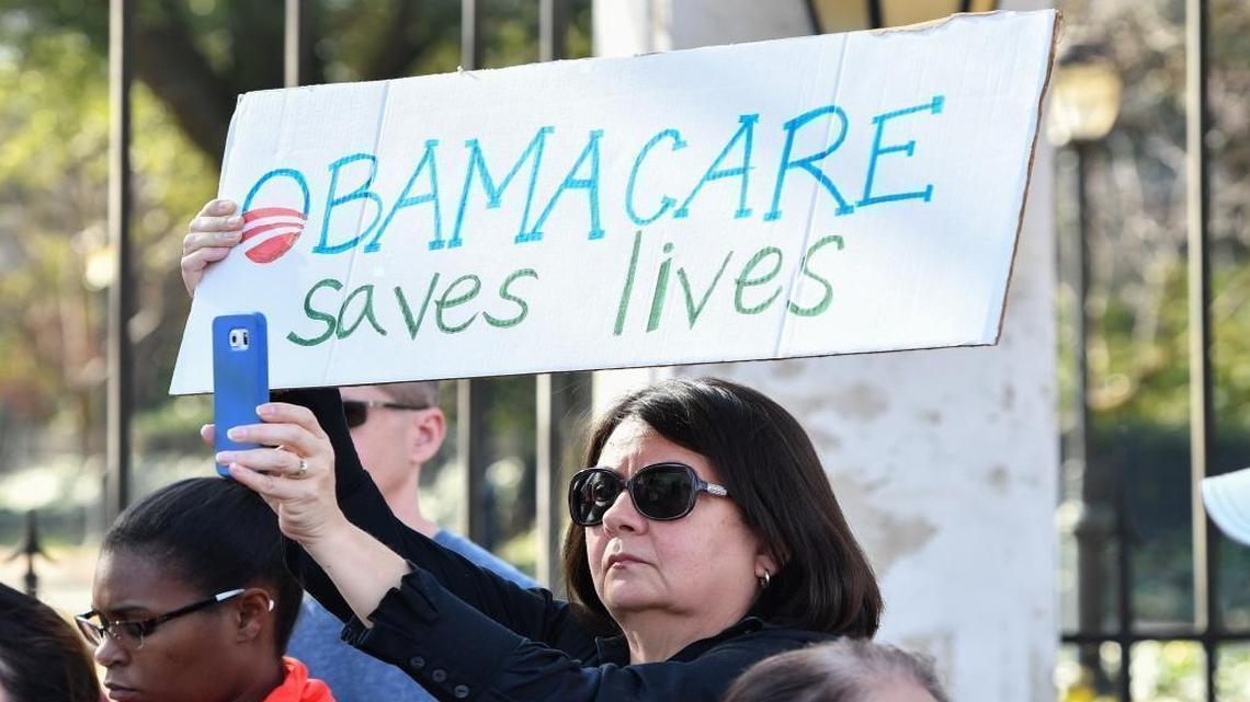 Affordable Care Act supporter Lucero Mesa holds a sign during an ACA support rally at the South Carolina Governor's Mansion.