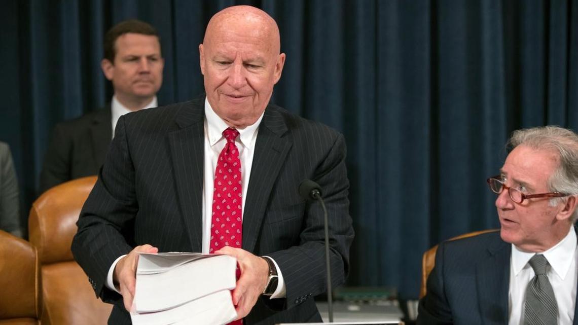 House Ways and Means Committee Chairman Kevin Brady, R-Texas, joined by Rep. Richard Neal, D-Mass., right, the ranking member, carries copies of the IRS Code as his panel begins the markup process of the GOP's far-reaching tax overhaul Monday.