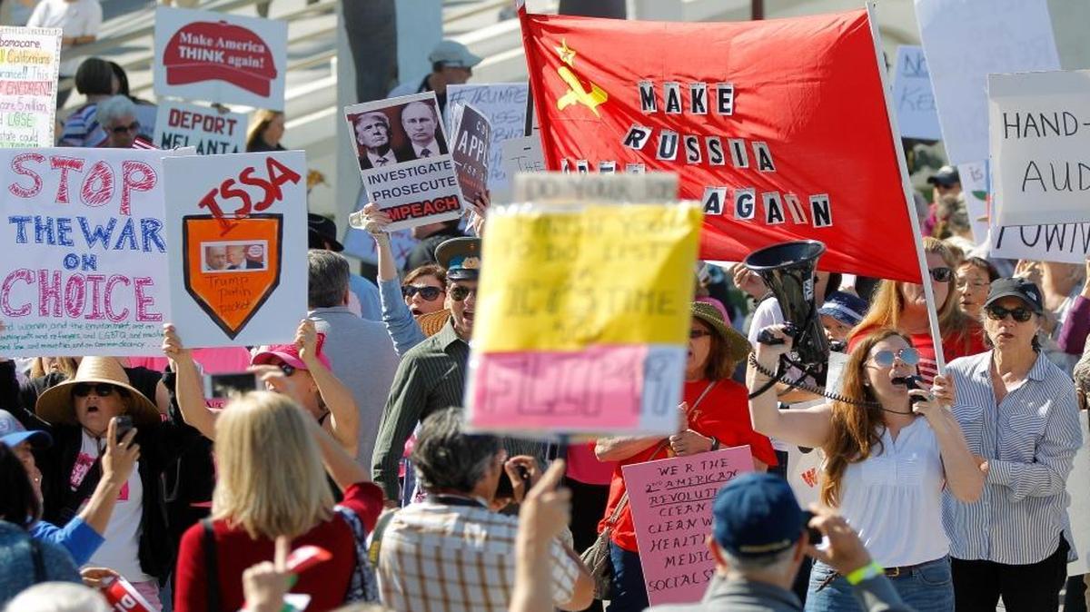 People protest outside the Junior Seau Beach Community Center as U.S. Rep. Darrell Issa, R-Calif., holds a town hall meeting inside on March 11, 2017, in Oceanside, Calif.