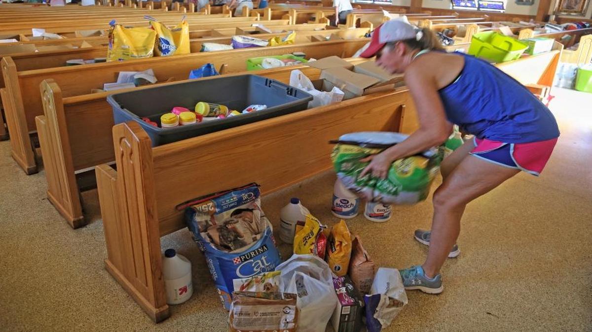 Palm City resident Sandy Burton drops off donated items during a Mass held for about 30 people on Sunday at San Pablo Catholic Church on Marathon Key, Fla. The church is also serving as a donation drop-off site for food, water and other basic necessities and has no electricity, but is structurally sound.