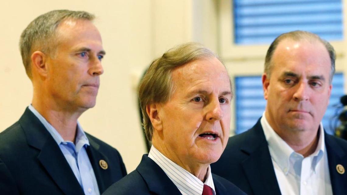 U.S. Representatives Robert Pittenger, center, Dan Kildee, right, and Jared Huffman, left, talk to media people at the Landstuhl Regional Medical Center in Landstuhl, Germany.