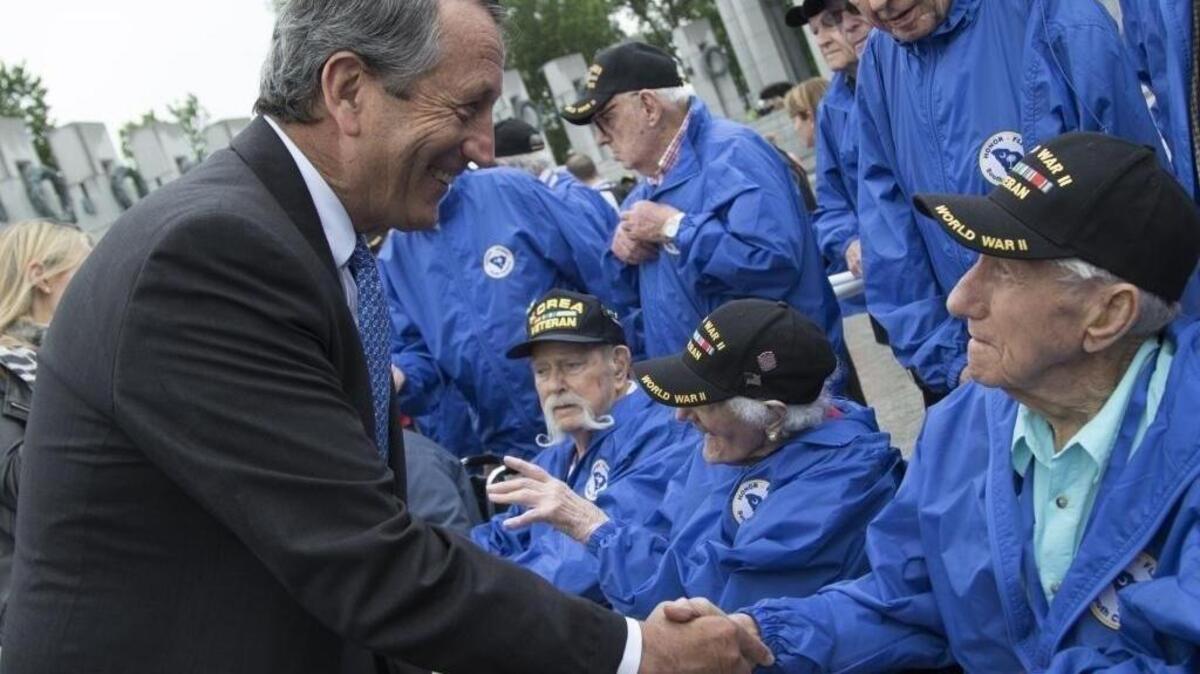 Rep. Mark Sanford, R-S.C., left, shakes hands with World War II veteran Francis Hughes of South Carolina when 66 World War II and Korean War veterans from Columbia, S.C., visit the World War II Memorial in Washington on May 11, 2016.