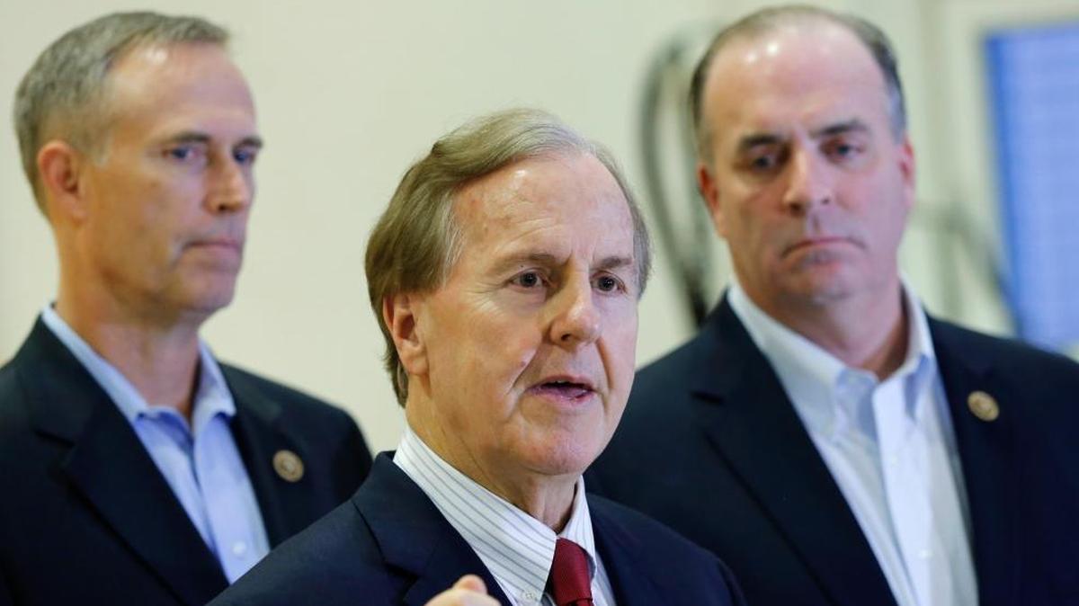 U.S. Representatives Robert Pittenger, center, Dan Kildee, right, and Jared Huffman, left, talk to the media,