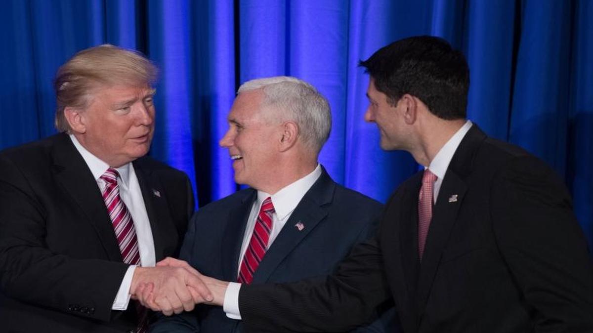 President Donald Trump, accompanied by Vice President Mike Pence, shakes hands with House Speaker Paul Ryan of Wis., Thursday, Jan. 26, 2017, prior to speaking at the Republican congressional retreat in Philadelphia.