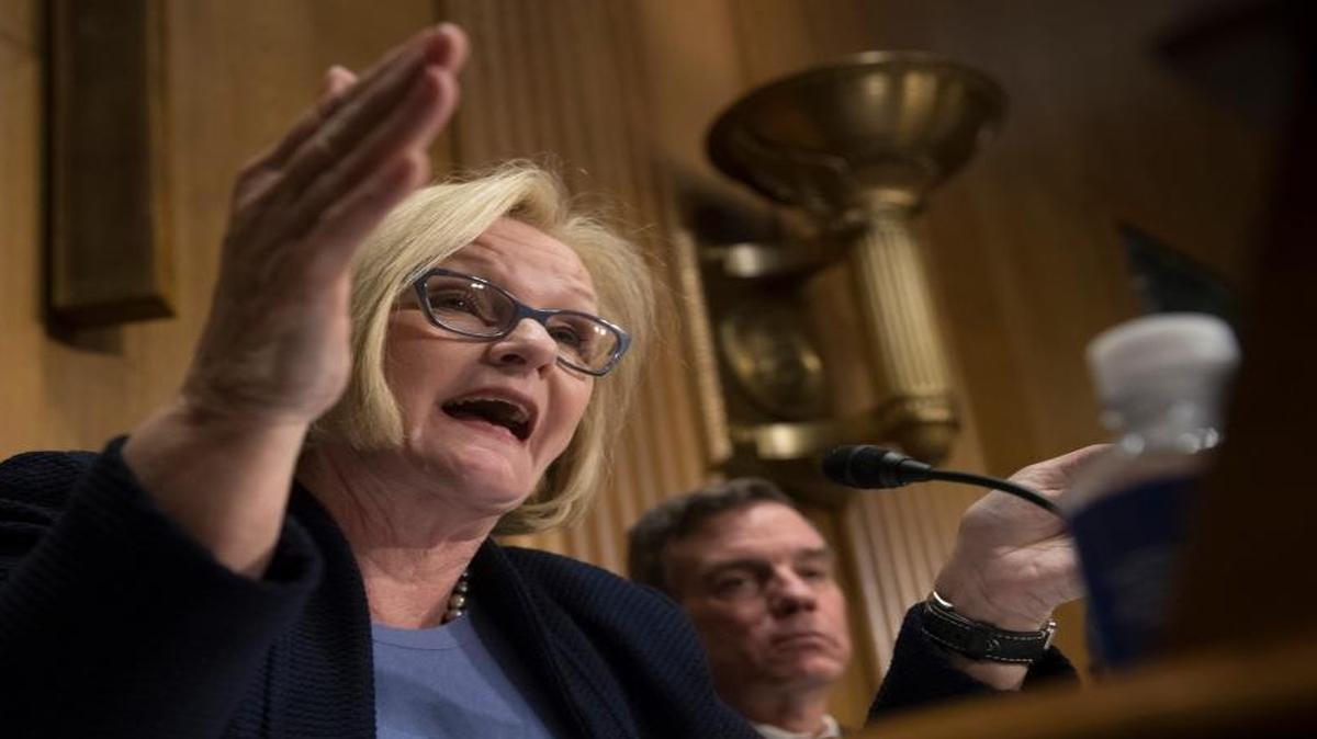 Senate Finance Committee member Sen. Claire McCaskill, D-Mo., joined by Sen. Mark Warner, D-Va., right, challenges Treasury Secretary-designate Steven Mnuchin about policies of his future boss, President-elect Donald Trump, Thursday, Jan. 19, 2017, during his confirmation hearing before the committee.