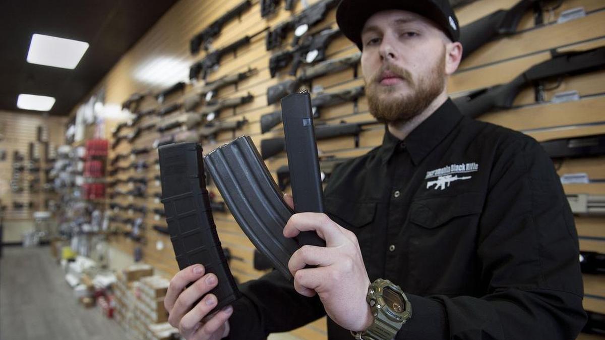 Nate Woodward, manager at Sacramento Black Rifle, holds high-capacity rifle and pistol magazines that under new California laws will be illegal to possess as of July 2017. A federal judge on Friday issued an injunction calling the law unconstitutional.