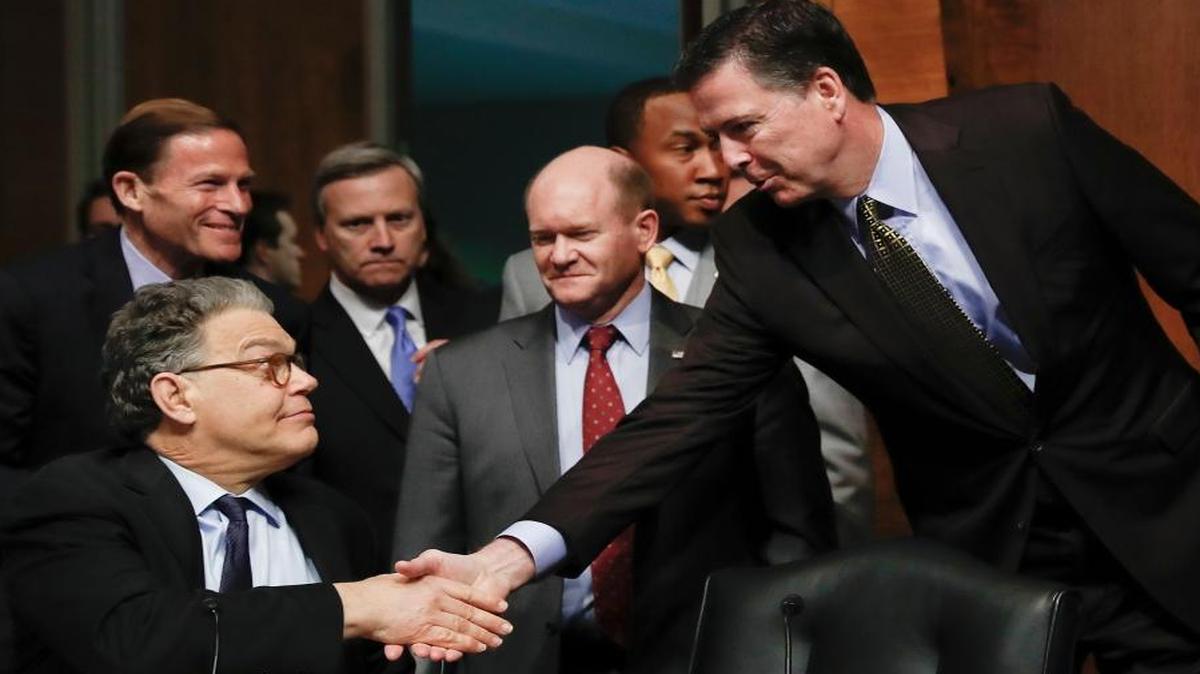 FBI then-Director James Comey shakes hands with Senate Judiciary Committee member Sen. Al Franken, D-Minn., as committee members Sens. Richard Blumenthal, D-Conn. (left), and Chris Coons, D-Del., watch on May 3, 2017.
